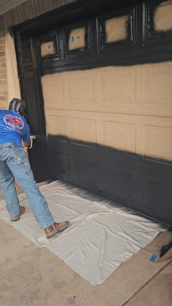 Texas Painting crew member preparing and painting a garage door